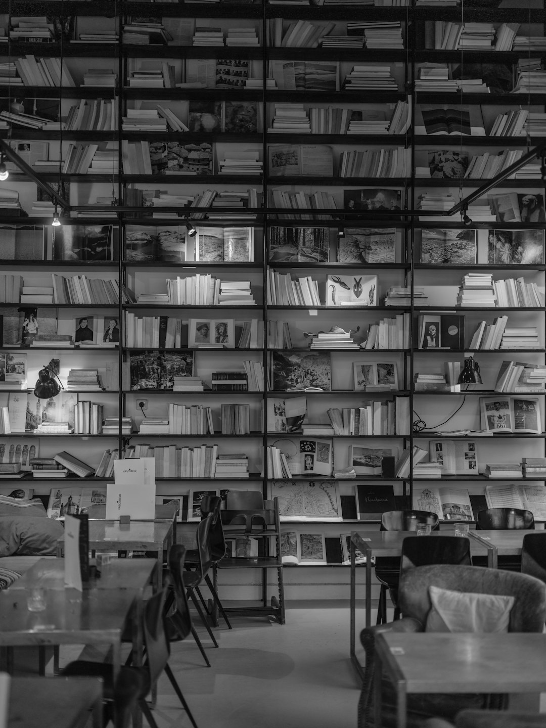 Floor to ceiling bookshelves fill a quiet cafe study area.